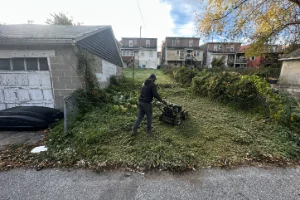 An employ brush mowing a residential lawn in Parkesburg, PA